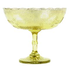 a yellow glass bowl sitting on top of a table