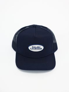 5-PANEL TRUCKER HAT FEATURING "MALIBU LACROSSE" PATCH Navy Snapback Hat With Flat Brim, Navy Adjustable Trucker Hat With Visor, Adjustable Navy Trucker Hat With Visor, Navy Flat Brim Snapback Hat, Navy Flat Brim Snapback Hat One Size, Navy Trucker Snapback Hat With Flat Brim, Navy Trucker Hat With Curved Brim, Navy Flat Brim Baseball Cap, One Size, Navy 5-panel Sports Hat