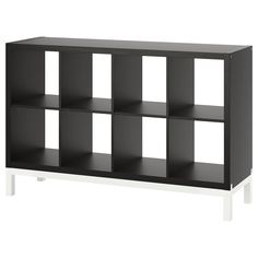 a black and white bookcase with six cubes on the bottom, one shelf is empty