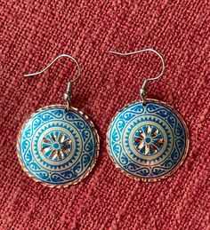 These traditional handmade earrings are made with a type of handiwork that dates back to the 17th Century in the Ottoman Empire. The gorgeous craftsmanship is rare and only 8 people are capable of this kind of handiwork today. Because of this, the craft of etching in copper is estimated to last for only another 10-15 years.  These are classic and timeless designs. The hooks of the earrings are Stainless Steel, and the jewellery itself is 100% Copper, which make them so lightweight. The backs are coated with Silver Nitrate, and both sides are polished with a high quality varnish so these pieces will not tarnish or discolour, are hypo-allergenic, and will hopefully get you compliments for time to come! Bohemian Hand-tooled Drop Earrings, Multicolor Round Copper Jewelry, Artisan Blue Beaded Round Earrings, Artisan Blue Earrings, Unique Hand Tooled Jewelry, Vintage Etched Earrings, Hand Tooled Artisan Gold Jewelry, Handmade Vintage Earrings For Festive Occasions, Handmade Vintage Festive Earrings