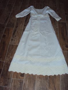 "Beautiful White Modest Linen And Venetian Lace Bridal Gown Size XS- S Excellent Vintage Condition, No Rips Or Tears, A Few Light Stains On The Bottom Inside Lining Of Train Fully Lined Empire Waist Dress Elbow Length Sleeves Rounded Boat Neckline Back Metal White Zipper (Zips Fine Too Small For My Dress Form) 6\" X 1.75\" White Bow Attached In Back Several Rows Of 3-5\" Venetian Lace Lace Is Slightly Differnt Shade Of White Very Fitted Bodice With Darts And Venetian Lace Around Empire Waist A L Cream Floor-length Gown With Lace Trim, Regency Style Empire Waist Wedding Gown, Wedding Night Gown With Lace Trim And Fitted Bodice, Wedding Night Gown With Fitted Bodice And Lace Trim, Floor-length Lace Trim Gown For Ceremony, Ceremony Floor-length Gown With Lace Trim, White Regency Style Vintage Dress For Formal Occasions, White Regency Style Formal Gown, Floor-length Wedding Dress With Lace Trim