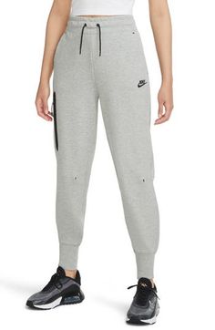 Nike's signature Tech Fleece provides soft and lightweight warmth in relaxed sweatpants with a wide waistband and extended banded cuffs. 28" inseam; 9 1/2" leg opening; 12 1/2" front rise; 16" back rise (size Medium) Elastic/drawstring Front slant pockets; front zip pocket 69% cotton, 31% polyester Machine wash, tumble dry Imported Women's Clothing Nike Tech Pants, Sport Street Style, Nike Tech Fleece Joggers, Tech Pants, Nike Sportswear Tech Fleece, Girls Joggers, Women's Sportswear, Nike Tech Fleece, Nike Tech