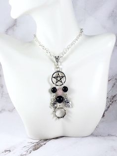 This beautiful chain necklace is the perfect way to express your affinity for the Greek gods Hades and Persephone.Pendant is made with four charms:PentacleFlowerCrownPomegranate3 genuine obsidian beads and one rose quartz bead also make up the pendant.Available in a variety of lengths. Secured with a lobster clasp that can fit in any of the links on the chain, making it easily adjustable.Made from zinc alloy. All materials are lead and nickel free.Comes in a jewelry box so it’s ready to be given Black Spiritual Chain Necklace, Spiritual Black Chain Necklace, Spiritual Black Chain Necklaces, Mystical Pendant Necklace With Adjustable Chain, Spiritual Pendant Charm Necklace With Chain, Spiritual Necklace With Adjustable Chain, Spiritual Dangle Necklace With Adjustable Chain, Black Bohemian Jewelry With Charms, Spiritual Metal Charm Necklace With Adjustable Chain