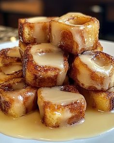 a white plate topped with cubes of bread covered in icing