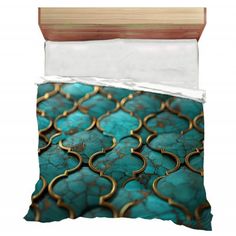 an image of a bed set with blue and gold designs on the sheets, along with a wooden headboard