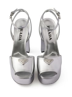 Find PRADA 115mm Leather Platform Sandals on Editorialist. silver-tone leather metallic finish enamel triangle logo silver-tone hardware square open toe buckle-fastening ankle strap 115mm block heel branded leather insole platform sole Modern Silver Patent Leather Heels, Silver Heels With Heel Strap In Patent Leather, Luxury Metallic Patent Leather Heels, Silver Patent Leather Heels With Heel Strap, Luxury Silver Heels With Buckle Closure, Luxury Metallic Open Heel Shoes, Silver Patent Leather Platform Heels, Luxury Silver Sandals With Block Heel, Luxury Silver Block Heel Sandals