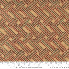 an orange and brown woven fabric with small squares on the bottom, along with a ruler