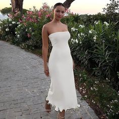 A woman wearing a tube midi dress with frill trim detailing Masters Motivation, Summer Evening Wear, White Strapless Midi Dress, Tube Midi Dress, Leaf Skirt, Long Dress For Women, Backless Long Dress, Maxi Dress For Women, Fashion Gowns