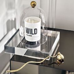 a glass table topped with a vase and a gold handle