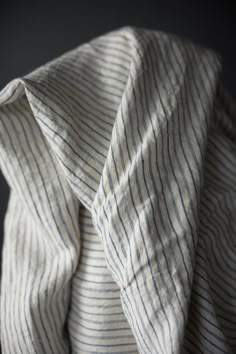 an unbuttoned white and blue striped shirt