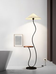 a lamp that is on top of a table next to a chair and a wall