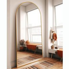 a large mirror sitting on top of a wooden floor