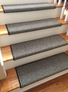 a set of stairs with black and white carpet