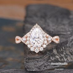 a diamond ring on top of a rock