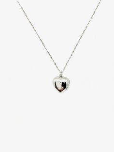 Embrace the nostalgia of the past and celebrate your love story with this heart-shaped sterling silver locket. A symbol of enduring love, this vintage gem is not just jewelry; it's a classic piece that spans decades. Discover timeless love with our Silver Jane Locket, a unique vintage treasure straight from the 1960s. The secure click-shut design ensures your cherished memories stay safely tucked away. The 17" sterling silver chain elegantly complements the locket, adding a touch of sophisticati Vintage Charm Heart Pendant Jewelry For Anniversary, Elegant Heart Pendant Necklace With Vintage Charm, Heirloom Sterling Silver Jewelry With Vintage Charm, Heirloom Heart-shaped Jewelry With Vintage Charm, Elegant Heart Necklace With Vintage Charm As Gift, Dainty Double Heart Locket Necklace, Elegant Heart-shaped Jewelry With Vintage Charm, Heart Cut Locket Necklace With Heart Charm For Anniversary, Elegant Heart Shaped Locket Necklace