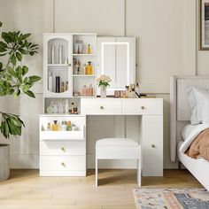 a bedroom with a bed, dresser and mirror in it's corner area next to a plant