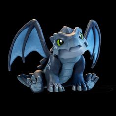 a blue dragon figurine sitting on top of a black surface with green eyes