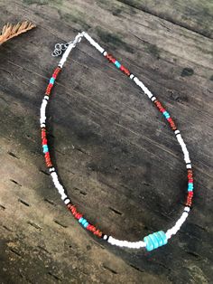 Colorful beaded necklace with turquoise center. Turquoise Tiny Beads Choker Necklace, Bohemian Turquoise Necklace With Spacer Beads, Bohemian Turquoise Necklace With Colorful Heishi Beads, Handmade Adjustable White Turquoise Necklace, Bohemian Turquoise Necklace With Round Spacer Beads, Adjustable Turquoise Hand-strung Beaded Necklace, Southwestern Turquoise Necklace With Tiny Beads, Spiritual Beaded Turquoise Necklace For Festivals, White Beaded Crystal Necklaces For Festivals