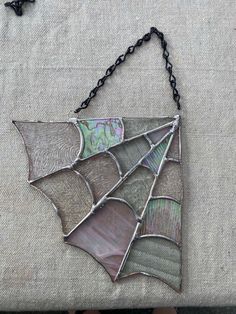 a piece of stained glass hanging from a chain