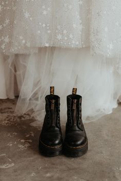 a pair of black boots sitting on top of a floor