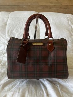 In gorgeous vintage condition! Vintage Polo Ralph Lauren Plaid Burgundy Crossbody Boston Bag Leather Trim. Zip Inner Pocket Dimensions: L 11 1/2" x H 9 1/4" x W 6 3/4" Vintage Ralph Lauren Bag, Classic Handheld Satchel With Dust Bag, Classic Brown Satchel With Dust Bag, Classic Handheld Satchel With Leather Lining, Vintage Brown Bag With Gold-tone Hardware, Vintage Bags With Leather Lining And Double Handle, Vintage Bags With Double Handle And Leather Lining, Vintage Crossbody Bag With Gold-tone Hardware, Vintage Satchel Tote With Gold-tone Hardware