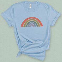 You'll feel radiant in this retro inspired rainbow graphic tee. Fun and cheery you'll brighten anyones day, with this rainbow t-shirt!DETAILSThis medium weight graphic t-shirt is super soft, comfy. It fits like a well loved favorite tee the first time you put it on, and is soon to become your go to tee. This durable crew neck, short sleeve shirt is made with superior combed and ring-spun cotton sure to flatter any figure. Check the size card to determine your perfect fit and for specific fabrica Rainbow Graphic, Rainbow T Shirt, Retro Rainbow, L And Light, Rainbow Print, Tees For Women, Pastel Rainbow, Graphic Tees Women, Soft Pastel