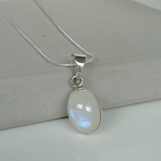 "\" Moonstone Is a stone for new beginnings, Inner growth and strength\" ▪︎ An oval moonstone. This stone is mounted on a simple sterling silver pendant frame. ▪︎ Size:- 17 x 13mm.   ▪︎ This multi purpose pendant can be used as a charm in necklaces, bracelets, anklets, key chains, zip pullers etc. ▪︎ This pendant is handmade with hypoallergenic sterling silver. Most of my pieces are marked with a 925 silver stamp. ▪︎ Please note: This listing is for ONE pendant  and comes WITHOUT the chain, however, you can add a snake chain in the required length while making your selection. You can also opt to choose other kinds of neck chains or bracelet chains from my shop  by visiting the links below. ▪︎ I can send this piece in a gift box or  include a gift message from you if required. ▪︎▪︎ Please r Minimalist Moonstone Pendant Crystal Necklace, Minimalist Moonstone Crystal Pendant Necklace, White Moon Phase Jewelry For Meditation, Spiritual White Birthstone Necklaces, Moon Shaped Gemstone Healing Necklace, Moon Shaped Gemstone Necklace For Healing, Spiritual Moonstone Pendant Necklace, White Crystal Necklace With Moon Phase For Gift, Oval Moon Phase Necklace As A Gift