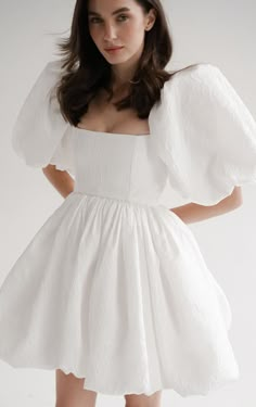 Short wedding dress crafted from textured taffeta, this gown features charming puff sleeves and a playful balloon skirt, exuding whimsical grace and modern elegance for your special celebration. Puff Wedding Dress, Wedding Dress Elopement, Wedding Dress Crafts, Light Feminine, Balloon Skirt, Exquisite Gowns, Elopement Dress, Bridal Shower Dress, Art Dress