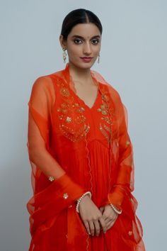 Royal orange georgette anarkali with zardosi hand embroidered yoke. Comes with a silk organza dupatta.
Components: 2
Pattern: Hand embroidered
Type Of Work: Zardosi
Neckline: V Neck
Sleeve Type: Sleeveless
Fabric: Anarkali : Georgette, Dupatta : Silk organza
Color: Orange
Other Details: 
Disclaimer : The product will dispose off some color, since it is hand dyed.
Occasion: Sangeet - Aza Fashions Orange Choli With Sheer Dupatta For Festive Occasions, Elegant Orange Choli With Zari Work, Festive Orange Choli With Sheer Dupatta, Elegant Orange Choli For Diwali, Elegant Orange Choli With Resham Embroidery, Elegant Orange Choli With Dupatta, Elegant Orange Choli For Festive Occasions, Elegant Orange Choli For Festive Season, Elegant Festive Orange Choli