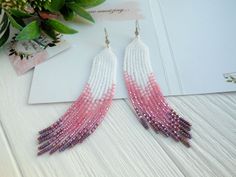 Pink romantic earring for women dangle , Long seed bead earring dangle, Birthday gift for girl , White and pink earrings color gradation Such combination of colors allows you to use these earrings with various types of clothing. Blouse, dress or casual wear - you will always have a beautiful look. Wearing such earrings attracts attention and allows you to get a lot of compliments to your person. If you are looking for a gift for your mom, girlfriend, sister or colleague, these earrings will be s Seed Bead Earring, Lesbian Gifts, Red Heart Earrings, Bead Earring, Romantic Earrings, Earring Dangle, Native Beadwork, Handmade Earrings Beaded, Earring For Women