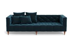 a blue couch with four pillows on it