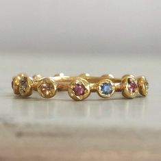 Eternity Gold Ring, Gold Sapphire Ring, Engagement Ring, Eternity Band, Gold Stacking band, Sapphire Engagement Ring, Anniversary Ring. Original and unique gold band with multi color sapphires set all around. Delicate and very classic, fine piece of jewelry. Solid 14 karat Gold, hand crafted. You can wear it as a single band, or stack it up for extra vibrant colors. Details - * 14 karat solid yellow gold. * Multi color Sapphires, set all around (14 stones all together). * Width - 3.5 mm / 0.4 in Adjustable Gold Stackable Rings With Multi-stone, Adjustable Gold Multi-stone Stackable Rings, Yellow Gold Multi-stone Stackable Promise Rings, 14k Gold Multi-stone Eternity Band, Adjustable Gold Birthstone Ring With Multi-stone, Gold Sapphire Stackable Adjustable Ring, Gold Stackable Sapphire Ring, Multicolor Stackable Round Band Rings For Anniversary, Multicolor Stackable Rings For Anniversary