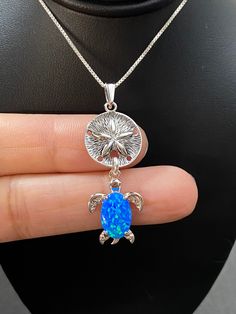 "Sterling Silver Sand Dollar and Turtle Charm Pendant Necklace Blue Opal Turtle Necklace Metal: All components are made from solid .925 Sterling Silver Measurement: pendant height is 44mm (1.7\") including bail and 16mm (0.63\") wide Choose Chain Length At Checkout You can find other charm jewelry in my shop here https://www.etsy.com/shop/LinksAndStones?ref=seller-platform-mcnav&section_id=24389019 Please feel free to Convo me with any questions before purchasing. Please view policy before p Ocean-inspired Blue Pendant Jewelry, Blue Pendant Jewelry For Beach, Ocean-inspired Blue Pendant Necklace, Blue Large Round Pendant Jewelry, Blue Round Large Pendant Jewelry, Ocean-inspired Blue Round Pendant Jewelry, Handmade Ocean Colored Pendant Jewelry, Handmade Ocean Color Pendant Jewelry, Ocean-inspired Nickel-free Blue Jewelry