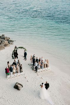 a couple getting married on the beach at their wedding