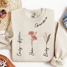 a sweater with the words grandma on it next to sunglasses and other items that include shoes