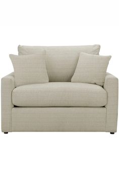 a couch with two pillows on it and one arm folded back to the side,