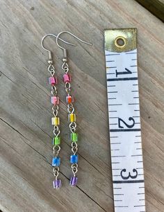 Cheap Silver Earrings With Colorful Beads, Rainbow Metal Earrings With Ear Wire, Rainbow Metal Earrings, Rainbow Dangle Metal Earrings, Multicolor Metal Dangle Crystal Earrings, Iridescent Drop Earrings For Jewelry Making, Rainbow Metal Drop Earrings, Rainbow Nickel-free Earrings For Gifts, Nickel-free Rainbow Earrings For Gift