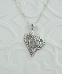 "925 Sterling Silver Filigree Art Women Heart Pendant Necklace, 18\"+2\" Silver Chain Option This 925 Sterling Silver handcrafted filigree art heart to heart pendant necklace comes with 20\" silver chain option. Beautifully crafted filigree details will catch all eyes on you. It is going to be exact match to your daily wear. It can also be perfect option for valentine`s day, mother`s day or birthday gift for yourself or your loved one. The pendant height is 1.65\" / 41.50 cm and the width is 1.05\" / 26.50 cm. The optional sterling silver chain is 18.00\"+2.00\" / 50 cm with extension and spring close closure. It is oxidized and highly polished. Filigree is a unique piece that incorporates handcrafted twisted threads of precious metal into its design. The metal is then soldered to the Silv Silver Jewels, Sterling Silver Filigree, Silver Filigree, Heart Pendant Necklace, Art Deco Fashion, Heart Pendant, Sterling Silver Chains, Sterling Silver Pendants, Silver Pendant