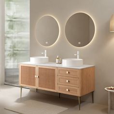 a bathroom with two sinks and mirrors on the wall