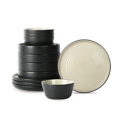 black and white dishes stacked on top of each other with one bowl in the middle