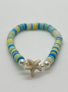 Handmade 7 in. preppy beaded bracelet. Contains blue, yellow, and clear clay beads. Also has pearl beads, and a cute starfish bead!! This is an adorable summer bracelet, and it would be the perfect gift for anyone and even for yourself! Handmade clay bead bracelet.  I can custom create any jewelry for you. Just let me know what colors you want, and if you want a word on it or not. I can also make phone charms and rings, and necklaces.