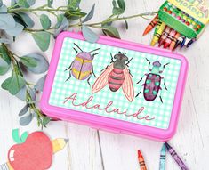 "Are you looking for a cute pencil case? How about an insect personalized pencil box? Start the new school year off right with fun bug personalized school supplies.  Send you kiddo back to school with a new personalized kids pencil box. We are sure they will love this beetle pencil box. * This plastic pencil box measures 8\"x4.5\"x2 and comes in a variety of colors. * Each decal is created with high-quality printable vinyl  * Optional upgrade to including a holographic laminate for extra sparkle Green Rectangular Stationery For Back To School, Playful Rectangular Pencil Case For Back To School, Green Rectangular Stationery For School, Playful Rectangular Stationery For Back To School, Playful Rectangular Craft Supplies For Back To School, Playful Pencil-shaped Craft Supplies For Back To School, Playful Pencil Case For Back To School Gift, Personalized Rectangular Pencil Case For Back To School, Educational Personalized Pencil Stationery