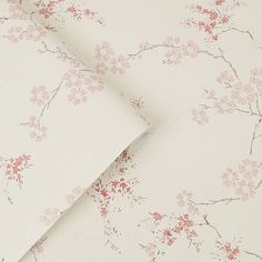 the wall paper has pink flowers on it