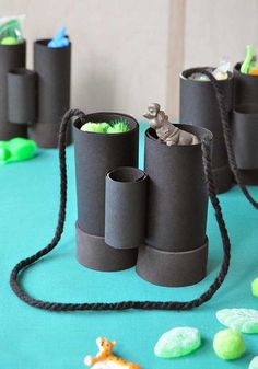 several rolls of toilet paper sitting on top of a blue table cloth covered in candy