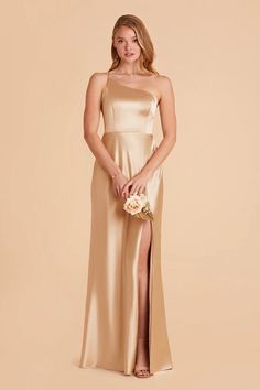 a bridesmaid in a champagne colored dress with a slited skirt and high slit