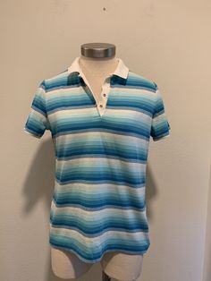 This is a nice vintage polo shirt. There are no tags or label. It measures like a small men's or a women's medium. Turquoise and white stripes with a white collar. There are two Metal Snaps for closure. It has a very small mark as shown in last photo, otherwise in great condition. I will be mailing this Priority Mail and First Class International. Measurements Bust or Chest ~ 36 Inch Waist ~ 34 Inch Shoulder to Shoulder ~ 15 Inch Length ~ 24 Inch Vintage Polo Shirt, Sheer Crop Top, 1960's Dress, Purple Blouse, Cotton Polo Shirt, Vintage Polo, Cotton Polo, White Collar, Vintage 1970s