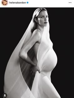 black and white photograph of a woman wearing a wedding dress with veil on her head