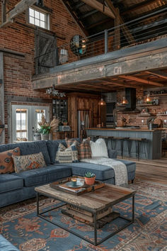 a living room filled with furniture next to a kitchen and dining area in a loft