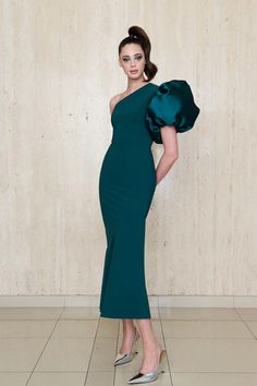 The Greta Constantine Amaryllis Dress features a striking asymmetrical neckline with an exaggerated flourish sleeve, creating a bold yet elegant look. This A-line gown balances a sleek silhouette with a dramatic statement sleeve, making it a standout choice for formal events and galas. True to size 68% polyamide | 32% elastane body Made in Toronto | Fabric milled in Italy Dry Clean *Note that Special Order pieces take 22 - 26 weeks to ship. Greta Constantine, Statement Sleeves, Asymmetrical Neckline, A Line Gown, Turks And Caicos Islands, Trinidad And Tobago, Black Tie, Evening Wear, Formal Event