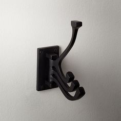 a black hook is attached to the wall